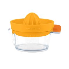 an orange juicer sitting on top of a glass container with a lid and handle