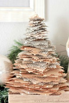 a book page christmas tree sitting on top of a table