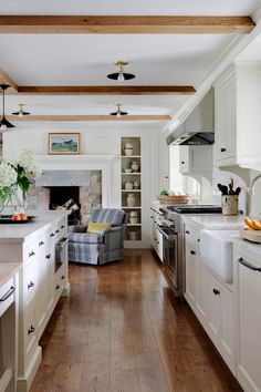 the kitchen is clean and ready for us to use it's white cabinetry