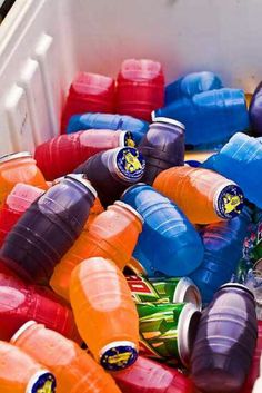 there are many different colored plastic bottles in the bins and one is filled with water