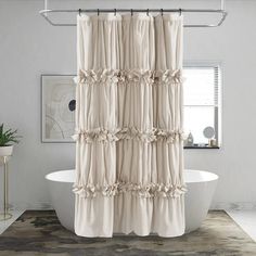 a white bath tub sitting next to a shower curtain