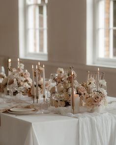 the table is set with candles and flowers