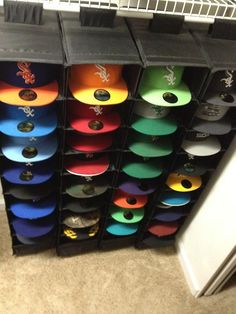 several bins with different colored lids are stacked on top of each other in a room