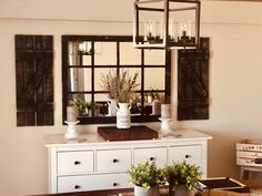 a dining room table with vases and flowers on it