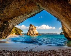 an ocean view from the inside of a cave