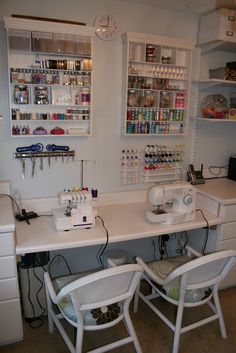 two white chairs sitting in front of a sewing machine