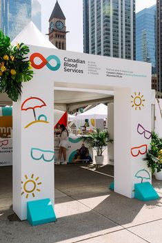 an outdoor tent with people standing under it