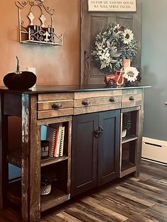 an old wooden cabinet with flowers on top