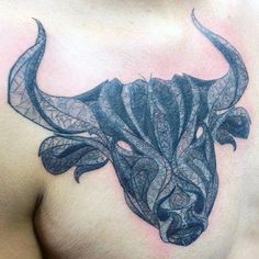 a bull's head with intricate patterns on its chest is seen in this tattoo design