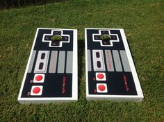 two game boards sitting in the grass