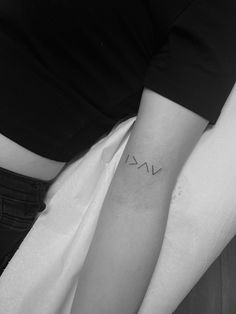 a woman's arm with the word love on it, and an arrow tattoo