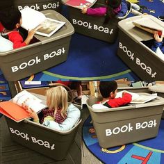 children are reading books in small boats on the floor