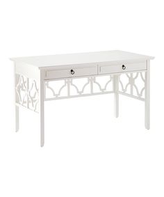 a white desk with two drawers on one side and an ornate design on the other