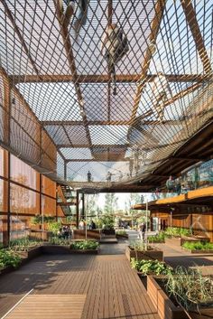 the inside of a building with lots of plants