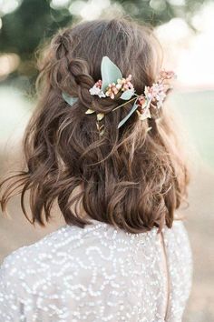 a woman wearing a flower crown in her hair