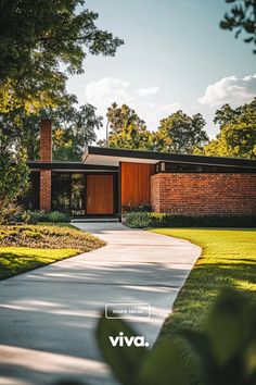 a brick house with a driveway leading to it