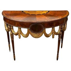 an ornately decorated console table with gold trimmings on the top and sides