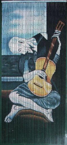 a painting on the side of a building with an image of a man playing guitar