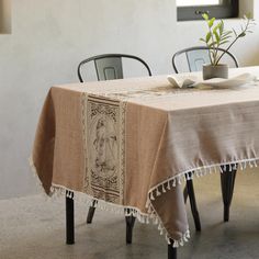 a table with two chairs and a potted plant sitting on top of the table