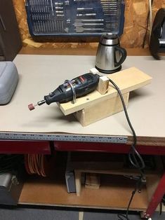 a cordless driller sitting on top of a workbench