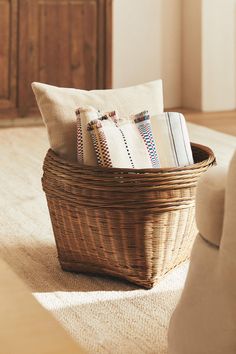 a basket filled with books on top of a rug