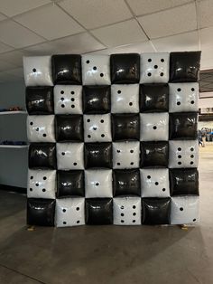 a large pile of black and white boxes stacked on top of each other in an office building