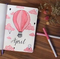 an open notebook with a hot air balloon drawn on it