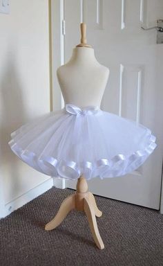 Stunning White Tutu Skirt, This beautiful white tutu skirt has been made with 2 layers of top quality soft tulle, with a lovely ribbon trim & a beautiful ribbon bow to match, which any princess would love! Stunning for any occasion All our lovely creations are CE & UKCA Tested. All our lovely tutu skirts are made to order. PLEASE BE AWARE that shades of tulle & ribbon may slightly differ from those illustrated due to the dying process  Your very welcome to follow us on our Facebook, Instagram & Tulle Skirt For Kids, Tutus For Women, Tutu Skirts, Professional Ballet Tutu, Tutu Dresses, White Organza Princess Dress With Tulle Skirt, Cute Tulle Skirt, White Organza Tutu Dress With Ruffles, Fitted Tulle Skirt For Dress-up