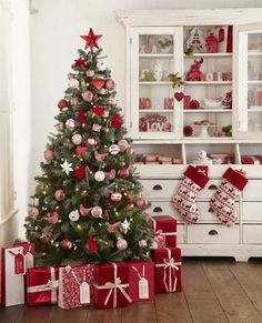 a decorated christmas tree with presents under it