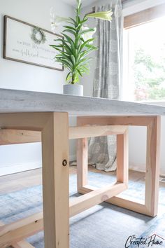 a wooden table with a potted plant sitting on it's top and bottom