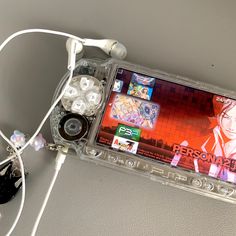 a nintendo wii game system sitting on top of a white table next to headphones