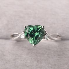 ◆ The ring is handcrafted from sterling silver and decorated with a dazzling 8*8 mm green sapphire and CZs. It is suitable for engagement/anniversary/daily occasion. ◆ Production Description: Main stone Type: Lab Green Sapphire Main Stone Shape: Heart Cut Main Stone Size: 8*8 mm(2.59ct) Side stone: CZ Metal: 925 Sterling silver - Other options available in the drop down menu ◆ Customization: √Free for Add Engraving √Other Metal Type Available √Other Gemstones & Shapes Available √Personalization Sage Green Promise Rings, Green Promise Rings For Her, Green Gem Rings, Green Diamond Heart Cut Ring, Heart-shaped Emerald Rings For Wedding, Fine Jewelry Green Heart Ring For May Birthstone, Green Heart Ring For May Birthstone, Fine Jewelry Style, Green Heart Ring For May Birthstone, Elegant Heart-shaped Emerald Ring For Anniversary