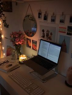 a laptop computer sitting on top of a white desk next to a keyboard and mouse