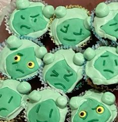 there are many cupcakes with green frosting on them