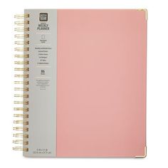 a pink and grey spiral bound notebook on a white background with the words weekly planner written in gold