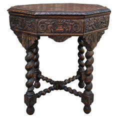 an old wooden table with carved wood legs and carvings on the top, isolated against a white background