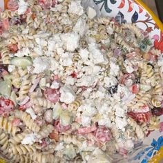 a bowl filled with pasta salad on top of a table