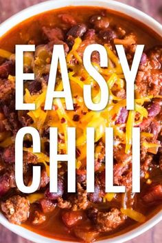 a bowl of chili with cheese on top and the words easy chili in white over it