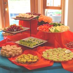 an assortment of desserts and pastries are on display at a buffet style table