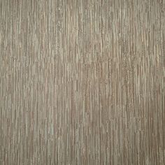 an upholstered wallpaper with vertical stripes in brown and beige colors, closeup