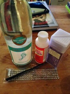 the contents of a wine bottle sitting on top of a wooden table next to other items