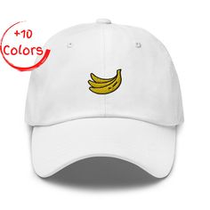 Celebrate your love for vibrant fruits with our stylish and comfortable "Banana" embroidered hat! This high-quality cap is perfect for fruit enthusiasts and anyone who wants to add a fun and playful touch to their outfit. Our Banana embroidered hat features: - Premium quality construction for durability and comfort - Classic six-panel design with a curved visor - Low-profile, unstructured style for a relaxed fit - Adjustable strapback closure for a custom and comfortable feel - "Banana" embroide Trendy Hat, Embroidered Hat, Summer Hat, Embroidered Hats, Tropical Fruit, Summer Hats, Panel Design, Trucker Cap, Low Profile