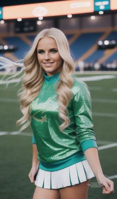 a woman with long blonde hair wearing a green and white cheerleader outfit at a football game