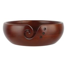 a wooden bowl with an intricate design on it