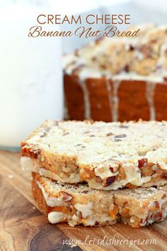 two pieces of bread sitting on top of a wooden cutting board next to a glass of milk