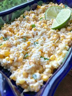 a casserole dish with corn, cheese and lime