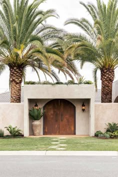 a house with palm trees in front of it