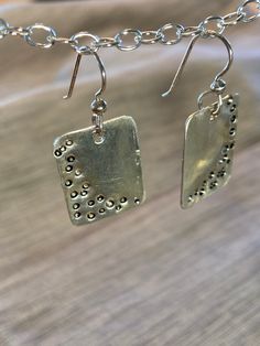 These earrings are shiny sterling silver w short square shape.  I have pounded dots into the silver and applied a black patina that filled in the dots so they are more visible.  They are versatile, could be worn for all occasions.  The ear wires are also sterling silver. Silver Rectangular Everyday Earrings, Silver Square Everyday Earrings, Everyday Silver Rectangular Earrings, Everyday Silver Square Earrings, Silver Hammered Rectangular Earrings, Nickel-free Rectangular Sterling Silver Earrings, Square Sterling Silver Earrings, Nickel-free Silver Square Pendant Earrings, Silver Square Metal Earrings