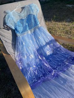 a blue and white dress sitting on top of a chair