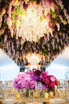 a table topped with lots of purple and pink flowers